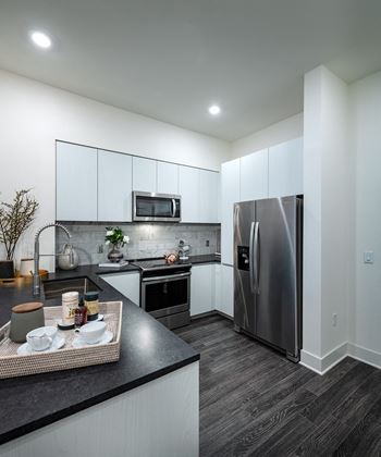 Kitchen with stainless steel appliances and a counter top at Kinley West LA, Los Angeles
